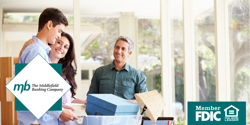 Parents smiling at son who is packing boxes up for college