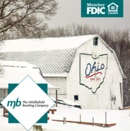 Snowy farm with the Ohio state logo on a white barn